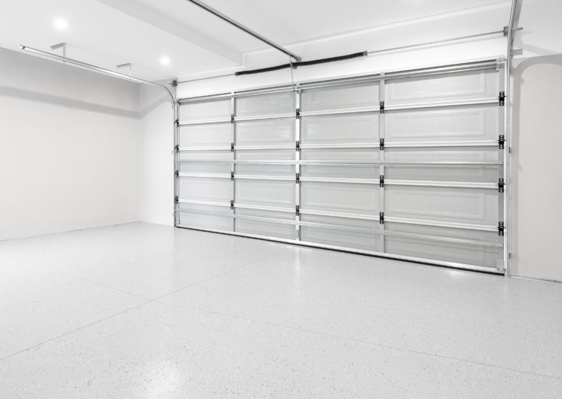 Garage Tex High End Garage Floor Project Beautiful image of white epoxy floor coating in a 2 car garage with white walls and white garage door highlighting Garage Tex's high end installation service.